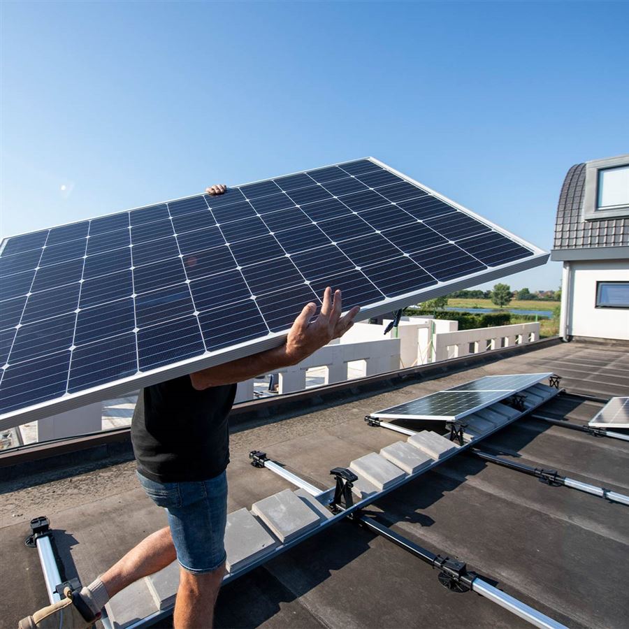 Man installerar solceller på tak. 