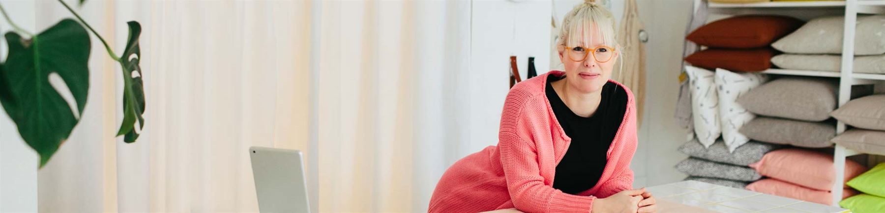 a woman behind the counter in a furniture store