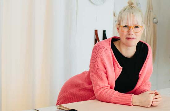 a woman behind the counter in a furniture store