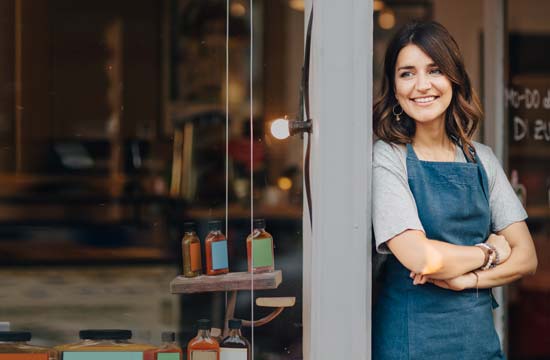 woman standing in the doorstep to her shop