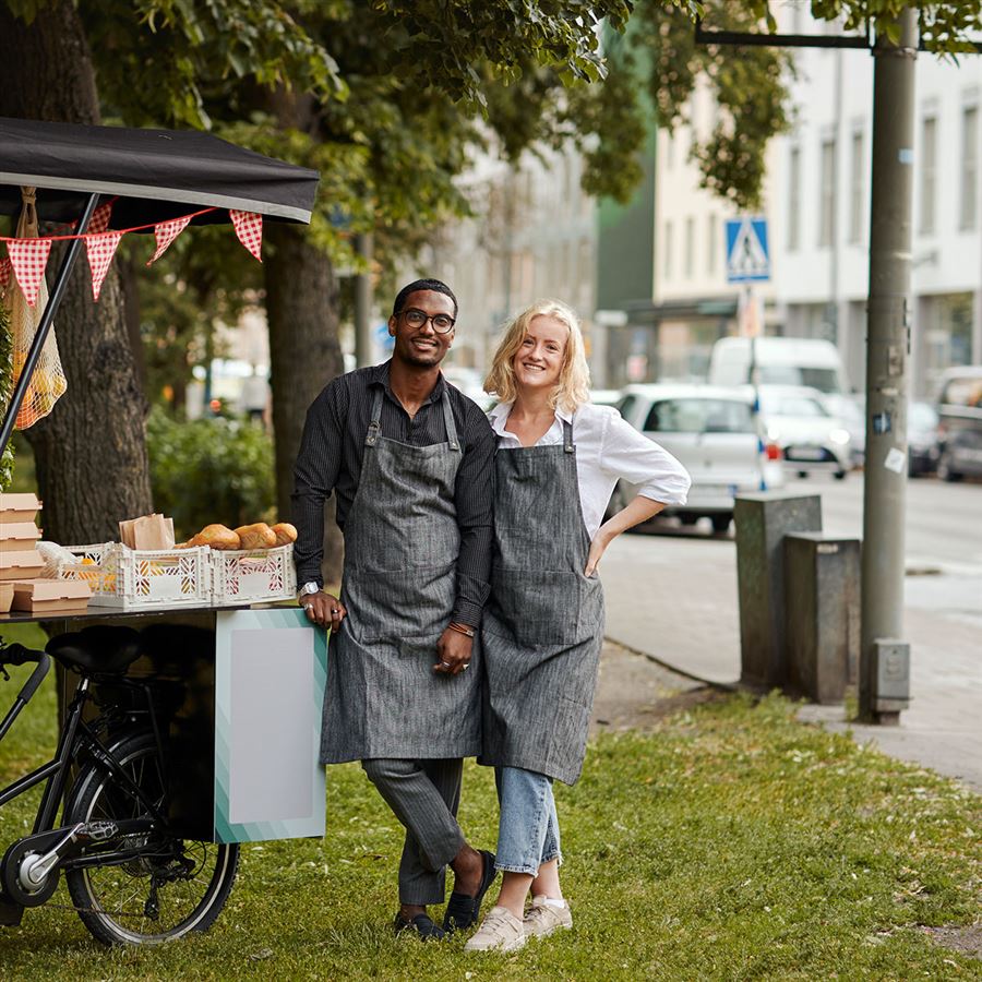 Ett par står framför sin cykel-foodtruck.