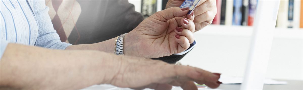 Hand of a woman holding a credit card.