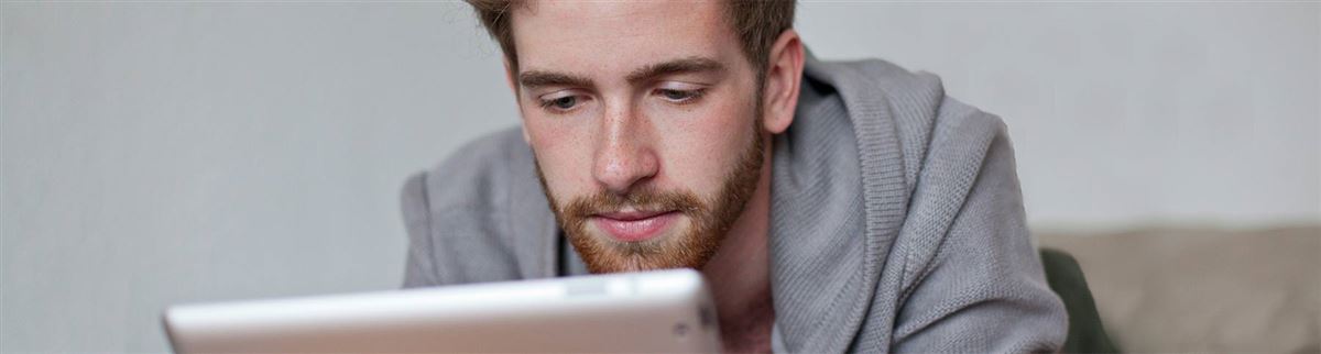 a man at home looking at a tablet