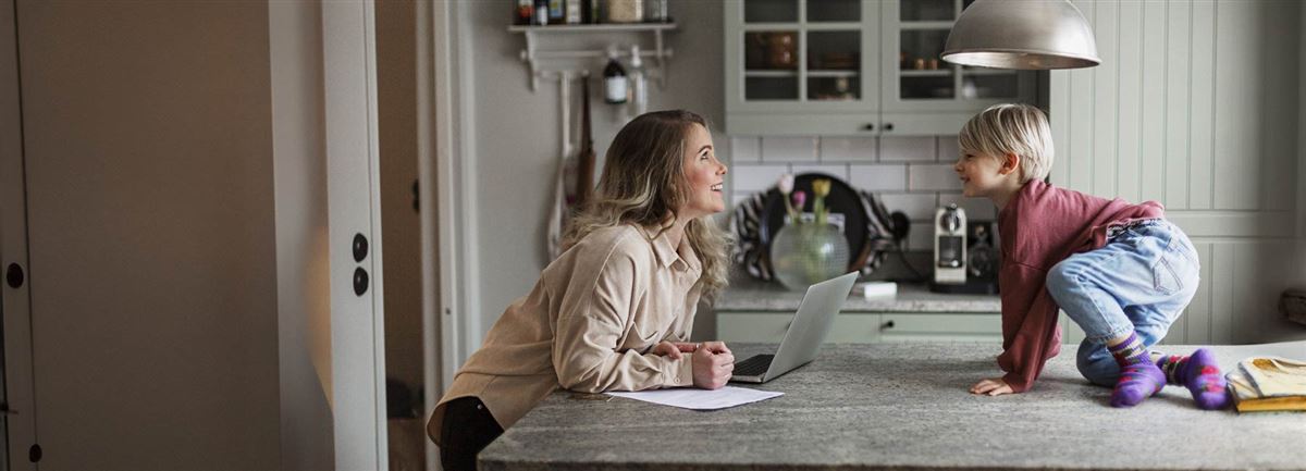 Mother working in the kitchen with her son