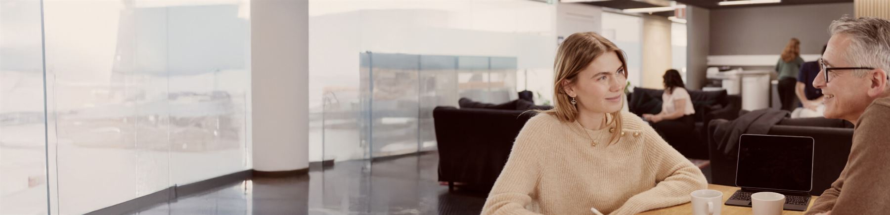 Female business owner is sitting by her desk.