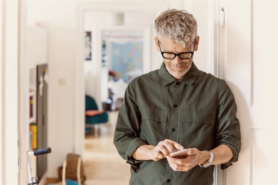 Man looking at interest rates on his phone.