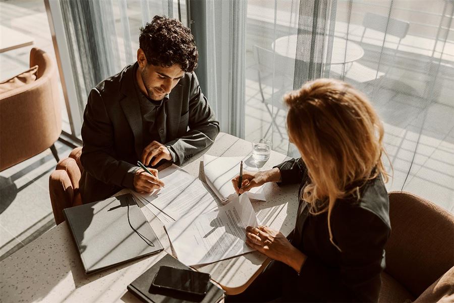 Colleagues discussing investments in a meeting.