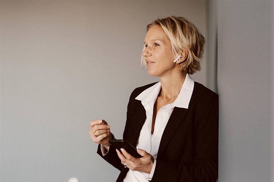 Woman wearing wireless headphones discussing pensions.