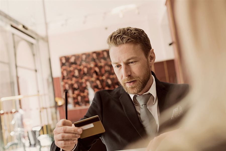 A man paying with his corporate credit card.