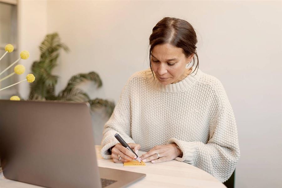 A woman sitting at her laptop comparing corporate cards.